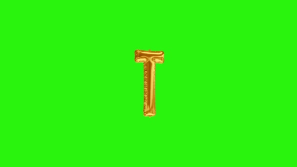 Gyllene bokstaven T. Guldfolie helium ballong alfabetet flyter på grön skärm — Stockvideo