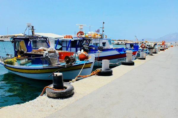 A group of colourful boats are docked next to a stoned berth in a summer time — Stock Photo, Image