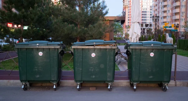 Three giant green trash bin