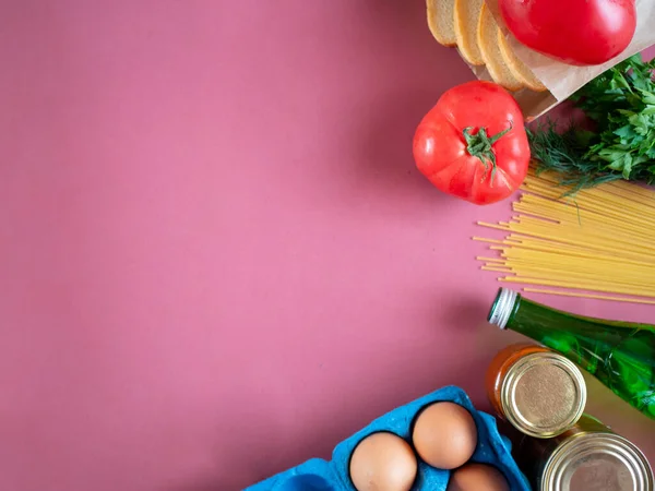 Food supplies on pink background, top view with copy space