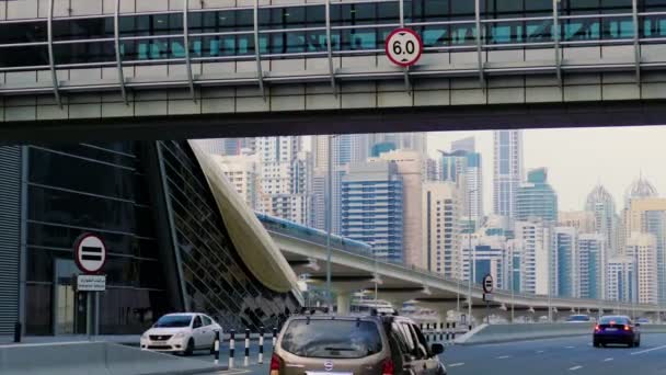Un paisaje urbano futurista con un cruce peatonal que cruza la autopista en Dubai, Emiratos Árabes Unidos — Vídeos de Stock