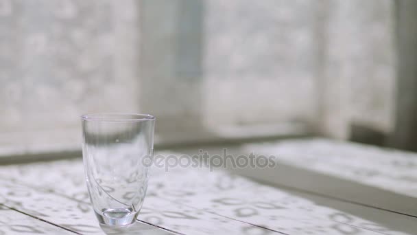 Male hand puts on the table an empty glass, raspberry jam and yogurt — Stock Video