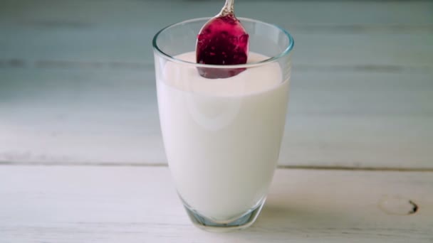 Mettere un cucchiaio di marmellata di lamponi nello yogurt — Video Stock