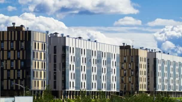 Residential quarter with modern six storey building on the background of floating clouds. Timelapse — Stock Video