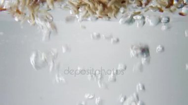 kahverengi ve kırmızı pirinç tahıl düşmek içine kaynar su. Makro görünümü