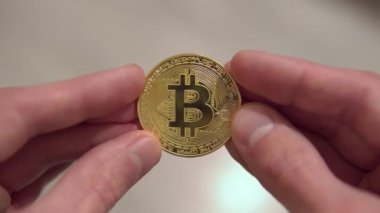 eller dönüyor mans kahverengi zemin üzerine altın Bitcoin
