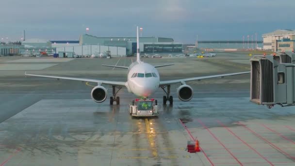 The tractor is towing the aircraft to a parking lot — Stock Video