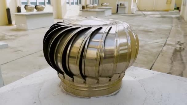 Metal silver spinning turbine ventilators commonly known as "whirlybirds" roof vents installed in the roof are the most effective and affordable way of cooling inside a house — Stock Video