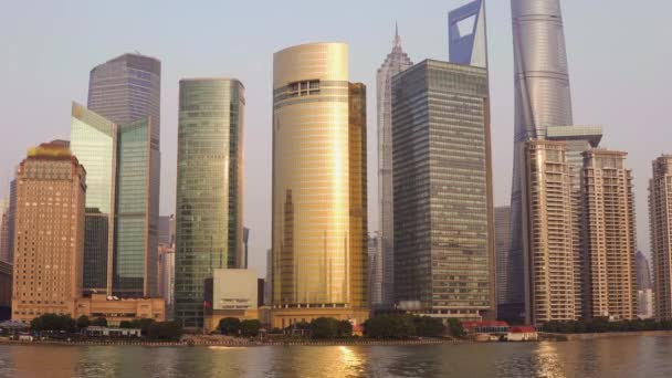 River bank with skyscrapers, landmarks of Shanghai with Huangpu river at sunrise or sunset in China — Stock Video