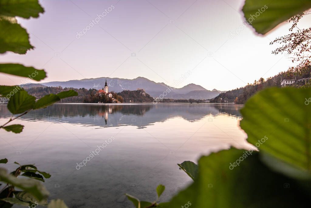 Autumn morning in the Bled Lake. The first rays of the sun illuminate the landscape. Bled Lake, the Upper Carniolan region of northwestern Slovenia.