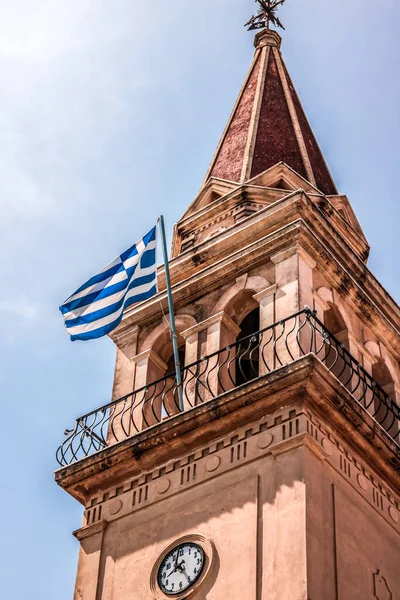 Waving Greek flag on tower of Church. Zakynthos, Greek island in the Ionian Sea