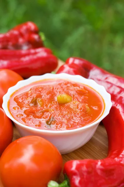 Hot peppers in tomato sauce with herbs and garlic — Stock Photo, Image