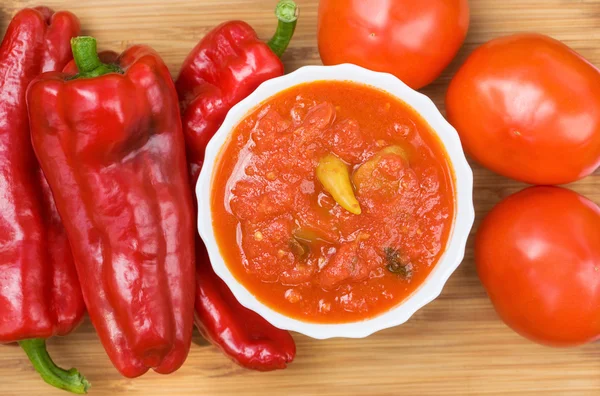 Hot peppers in tomato sauce with herbs and garlic — Stock Photo, Image