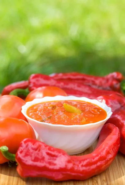 Hot peppers in tomato sauce with herbs and garlic — Stock Photo, Image