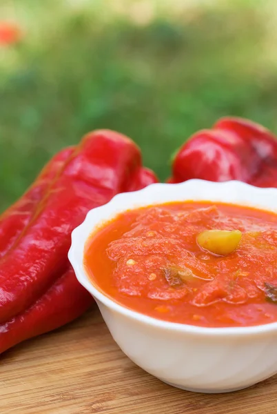 Hot peppers in tomato sauce with herbs and garlic — Stock Photo, Image