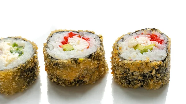 Scharfe Sushi-Rolle mit Lachs, Aal, Thunfisch, Avocado, Royal Garnelen, Frischkäse Philadelphia, Kaviar tobica, Chuka. weißer Hintergrund. — Stockfoto