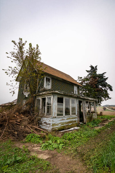 Old dilapidated abandoned farm house in rural Wisconsin.