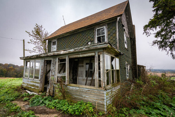 Old dilapidated abandoned farm house in rural Wisconsin.