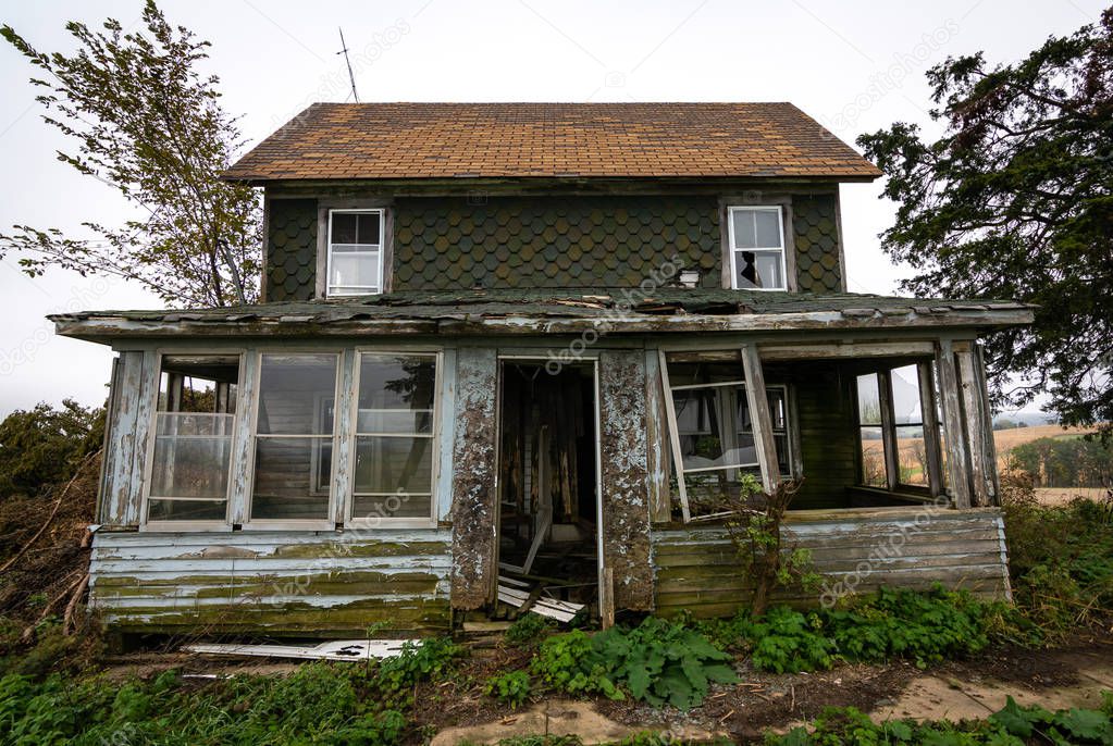 Old dilapidated abandoned farm house in rural Wisconsin.