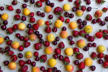 Taze meyveler ve meyveler. Olgun meyve, kiraz, çilek ve kayısı karışımı..