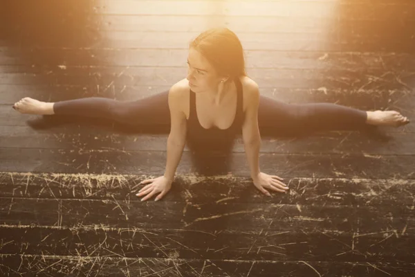 Вид зверху. Гімнастика вдома. Інструктор йоги показує, як робити розщеплення . — стокове фото