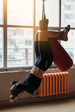 Yoga eğitmeni evde bir dizüstü bilgisayarla online egzersiz yapıyor. Sırt ve bacak kasları ve eğiklikleri için esneme egzersizleri.