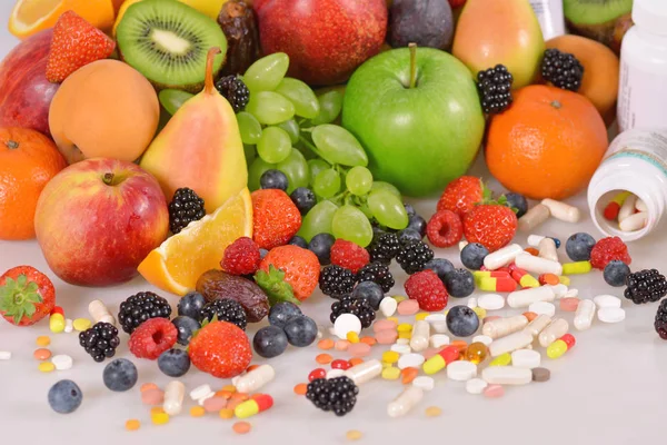 Berries, fruits, vitamins and nutritional supplements Stock Picture