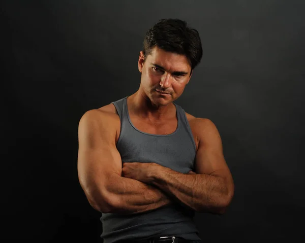 The handsome man is wearing a tank top — Stock Photo, Image