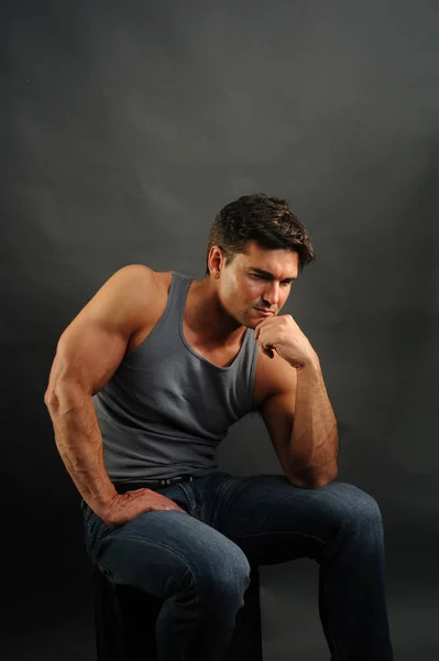 The handsome man is wearing a tank top — Stock Photo, Image