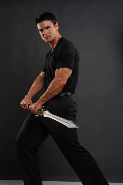 The spooky warrior is holding a sword — Stock Photo, Image