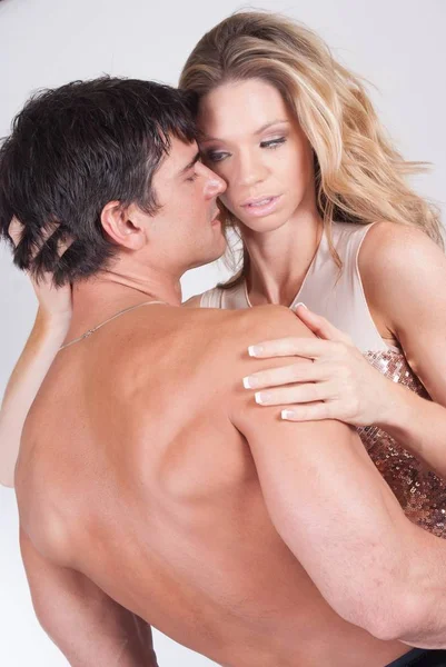 The sexy couple is in a loving embrace — Stock Photo, Image