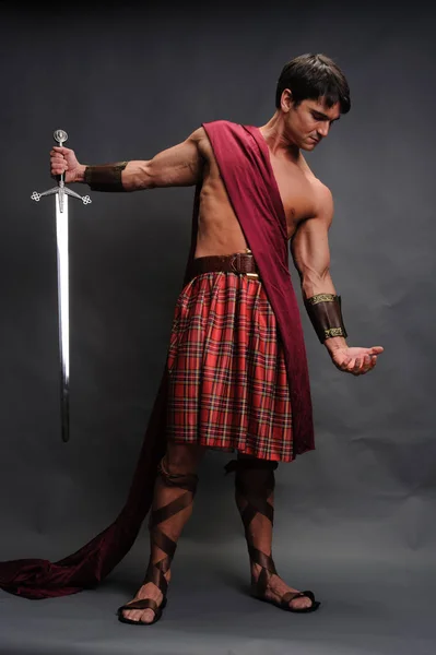 The loving highlander shows his muscles — Stock Photo, Image