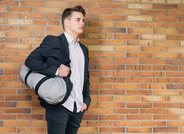 Portret Van Een Jongeman Met Een Sporttas Baksteen Muur Achtergrond — Stockfoto