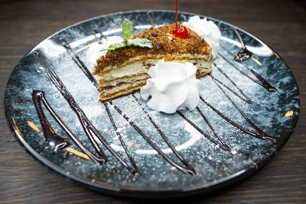 delicious honey dessert with chocolate, whipped cream and mint leaves