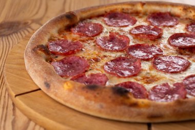 Tahta üzerinde sağlıklı İtalyan pizzası. Salamlı peynirli pizza.