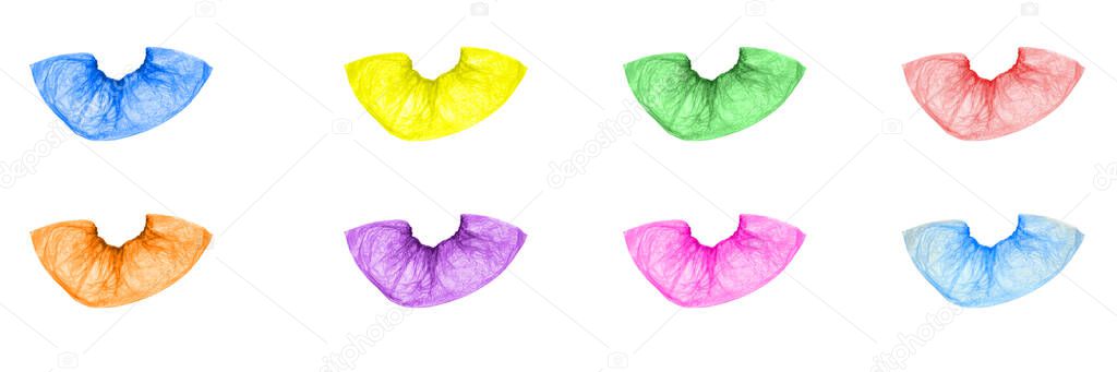 Isolated multicolored, disposable, medical Shoe covers on a white background. Shoe covers are blue, yellow, green, red, orange, pink, purple. The view from the top.