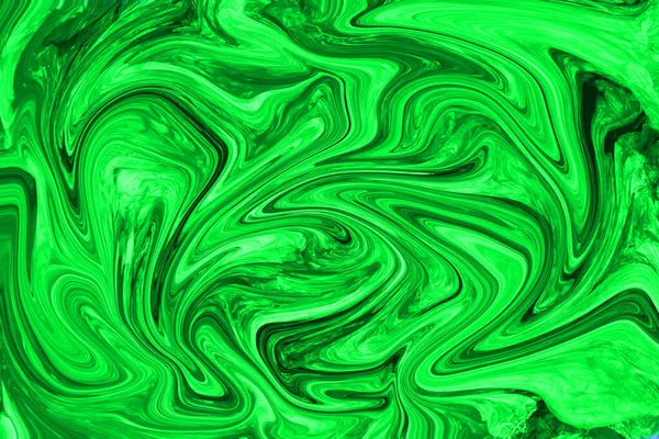 Abstract mixing of waves in the ocean, a sea of bright, poisonous green acrylic paint. Background, texture, and paint mixing concept. Mystical, fascinating, luxurious painting in colors.
