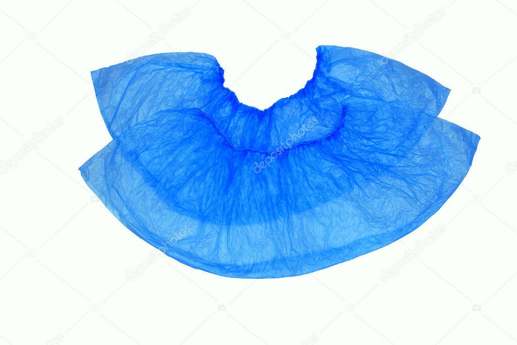 An isolated pair, two medical, blue, disposable Shoe covers on a white background, arranged on top of each other.