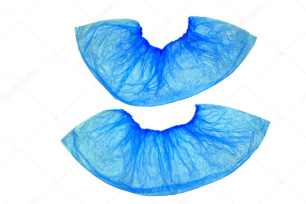 An isolated pair, two medical, blue, disposable Shoe covers on a white background, located under each other.