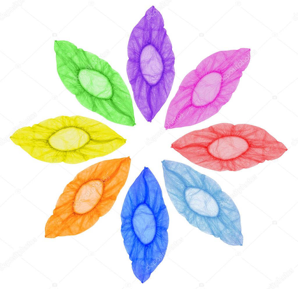 Isolated on a white background, multi-colored, open Shoe covers are arranged in a circle at the same distance in the form of a flower.Top view, the concept of the circle of the sun flower.