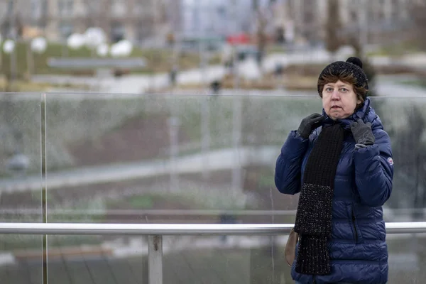 Russian lady with ladies handbag in park Zaryadie Moscow