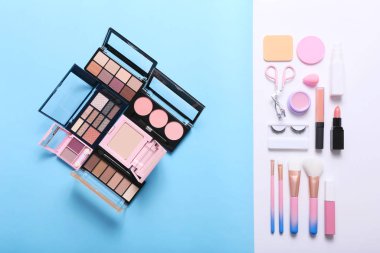 Set of professional decorative cosmetics, makeup tools and accessory on blue background.