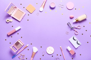 Set of professional decorative cosmetics, makeup tools and accessory on lilac colored background. Beauty, fashion and shopping concept. Flat lay composition, top view