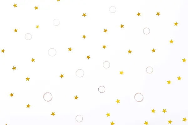 Schöner Hintergrund mit goldenen Ringen und Sternen, Draufsicht — Stockfoto