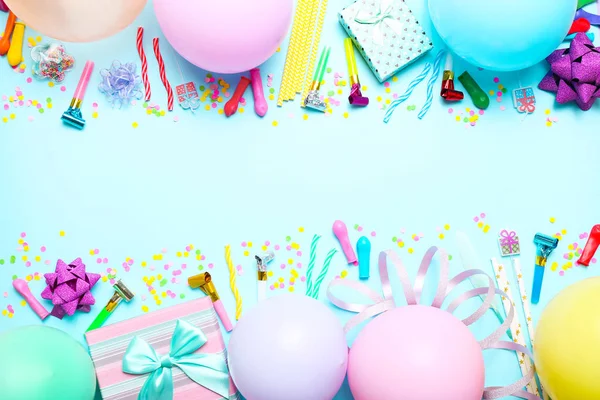 Colorful celebration background with various party confetti, balloons, gifts, and decoration on blue background. — Stock Photo, Image