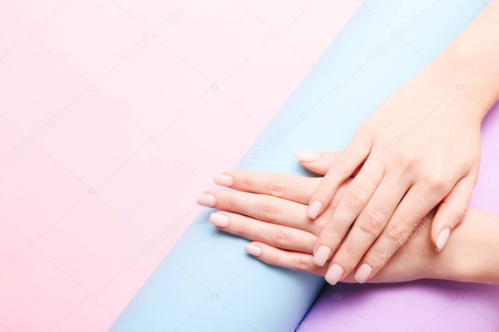 Beautiful woman manicure on creative trendy pastel background. Minimalist manicure trend. Top view, flat lay. Copy space for your text.