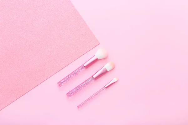 Conjunto de pinceles de maquillaje sobre fondo rosa. — Foto de Stock