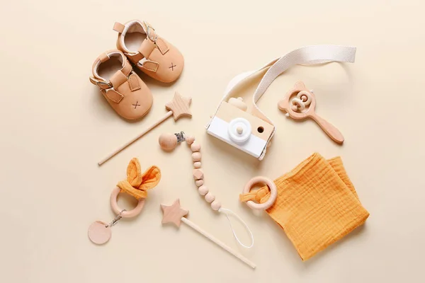 Set of baby shoes, toys and accessories on beige background. Fashion newborn stuff. Flat lay, top view — Stock Photo, Image