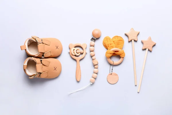 Conjunto de zapatos de bebé, juguetes y accesorios sobre fondo gris. Cosas de recién nacidos. Piso tendido, vista superior — Foto de Stock