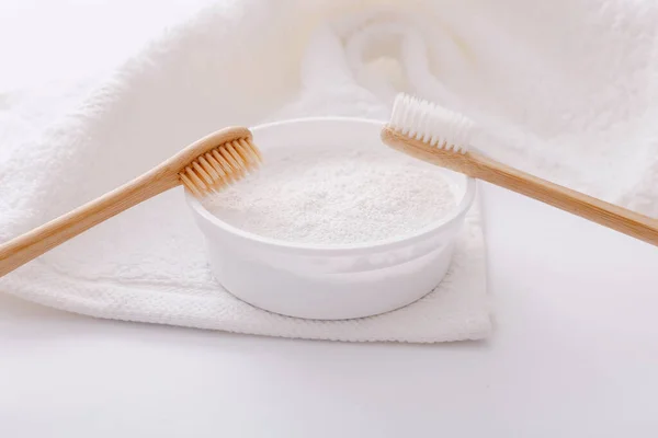 Wooden teeth brushes and tooth-powder on white towel backgroud. Zero waste concept — Stock Photo, Image